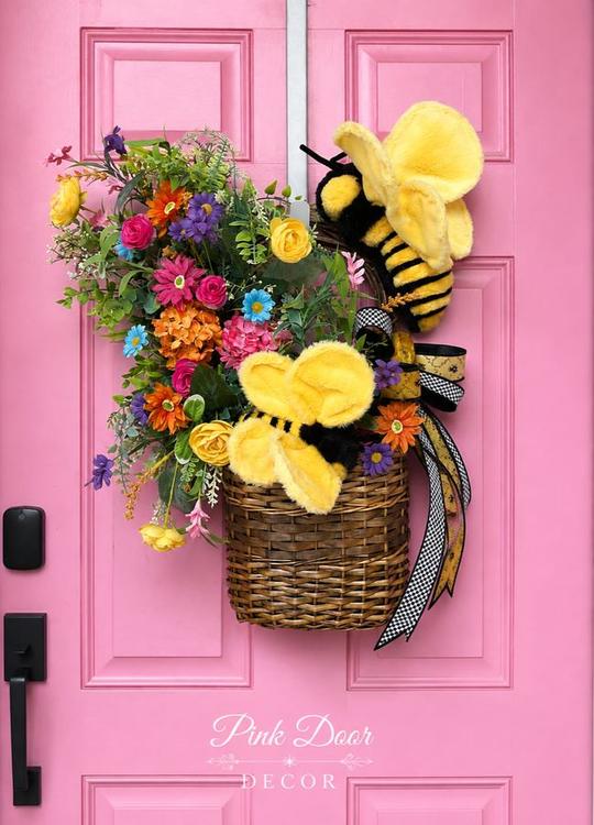 Bumblebee garden basket with wildflowers and plush bees on the pink door