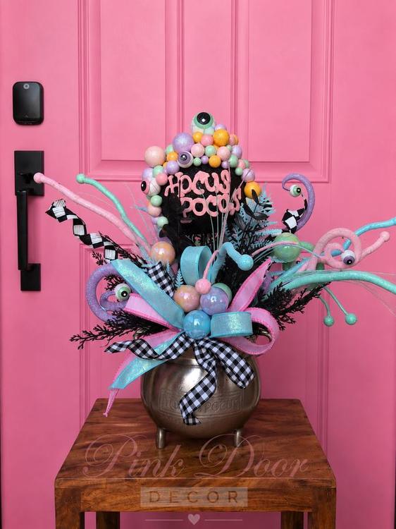 Pastel Hocus Pocus cauldron centerpiece with candy-colored orbs and eyeballs