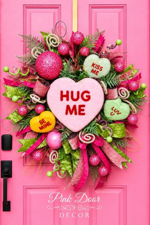 Conversation hearts Valentine wreath with candy hearts on the pink door